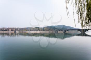 travel to China - view of Yi river and East Hill of Chinese Buddhist monument Longmen Grottoes (Dragon's Gate Grottoes, Longmen Caves) in spring season
