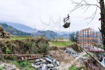 travel to China - Building a new house on hill of Dazhai village in area of Longsheng Rice Terraces (Dragon's Backbone terrace, Longji Rice Terraces) in spring season