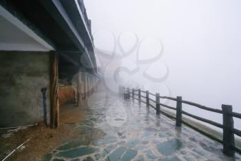travel to China - fog on street of Tiantouzhai village in area of Dazhai Longsheng Rice Terraces (Dragon's Backbone terrace, Longji Rice Terraces) in spring season