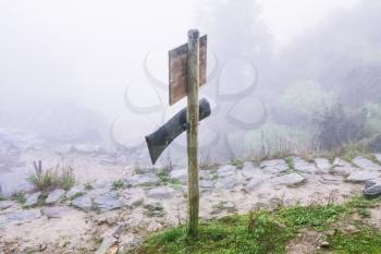 travel to China - direction sign on mountain path in misty spring day in area of Dazhai Longsheng Rice Terraces (Dragon's Backbone terrace, Longji Rice Terraces)
