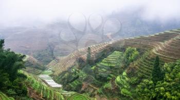 travel to China - view of terraced rice gardens over clouds from Tiantouzhai village in area Dazhai Longsheng Rice Terraces (Dragon's Backbone terrace, Longji Rice Terraces) country in spring