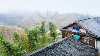 travel to China - houses in Tiantouzhai village and terraced fields in area Dazhai Longsheng Rice Terraces (Dragon's Backbone terrace, Longji Rice Terraces) country in spring