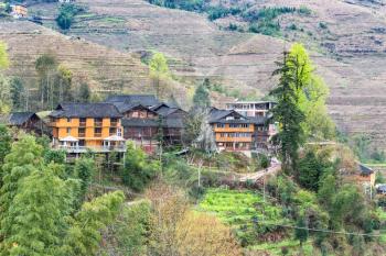 travel to China - view of wooden houses in village on terraced hill of Dazhai Longsheng Rice Terraces (Dragon's Backbone terrace, Longji Rice Terraces) country