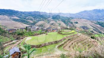 travel to China - view of village and viewpoint Golden Buddha Peak in terraced fields from Seven Stars Chase The Moon in Dazhai area Longsheng Rice Terraces (Longji Rice Terraces) country in spring