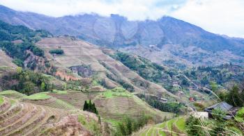 travel to China - view of terraced grounds in Dazhai country from viewpoint Seven Stars Chase The Moon in area Longsheng Rice Terraces (Longji Rice Terraces) in spring