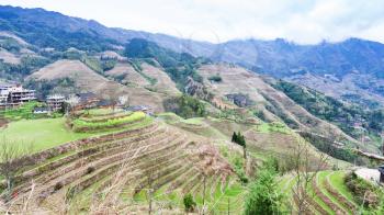 travel to China - view of rice terraced hills in Dazhai country from viewpoint Seven Stars Chase The Moon in area Longsheng Rice Terraces (Longji Rice Terraces) in spring