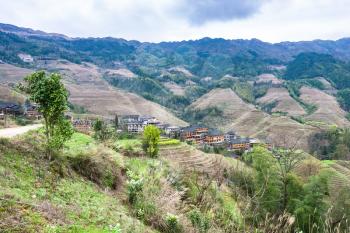 travel to China - view of Dazhai country with village from viewpoint Seven Stars Chase The Moon in area Longsheng Rice Terraces (Longji Rice Terraces) in spring