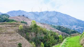 travel to China - view of hills near Dazhai village in country of Longsheng Rice Terraces (Dragon's Backbone terrace, Longji Rice Terraces) in spring