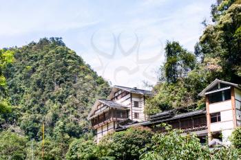 travel to China - apartment houses in green hills in Jiangdi village in Longsheng Hot Springs National Forest Park of Xiangshan District in spring season