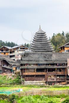 travel to China - tower and wooden houses in Chengyang village of Sanjiang Dong Autonomous County in spring