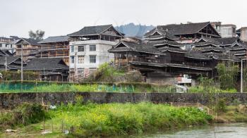 travel to China - country houses in on riverbank in Chengyang village of Sanjiang Dong Autonomous County in spring
