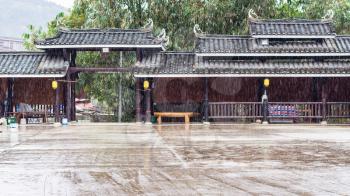 travel to China - rain over central square in Folk Custom Centre of Chengyang village of Sanjiang Dong Autonomous County in spring season