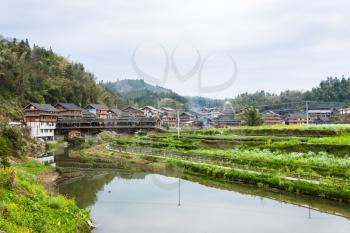 travel to China - view of gardens and covered Bridge in Chengyang village of Sanjiang Dong Autonomous County in spring season