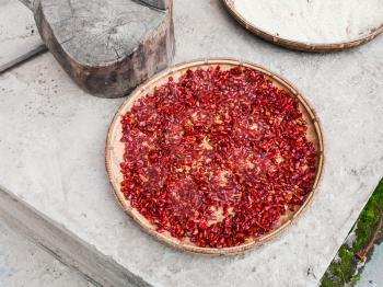 travel to China - pieces of paprika on plate dry outdoors in Chengyang village of Sanjiang Dong Autonomous County in spring season