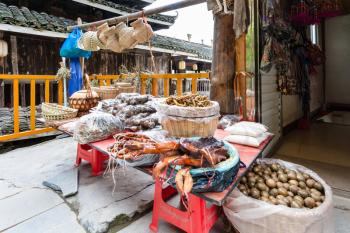 travel to China - stall with local products on market in Chengyang village of Sanjiang Dong Autonomous County in spring season
