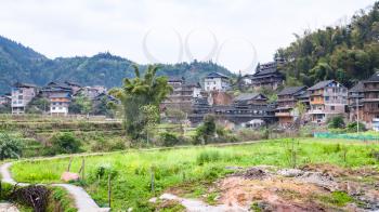 travel to China - view of Chengyang village with Bridge from backyards in area of Sanjiang Dong Autonomous County in spring morning