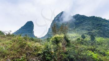 travel to China - cloud over mountain peaks in Yangshuo County in spring season