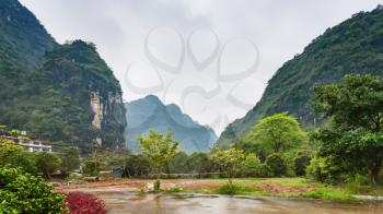travel to China - square in village in karst mountains valley in Yangshuo County in spring season