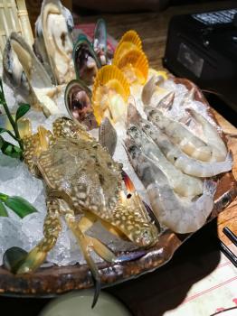 travel to China - fresh seafoods crab, shrimp, Clam, mussel, oyster on ice in chinese restaurant of Guilin city in spring season