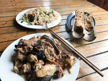 travel to China - chinese dinner with chicken and mushrooms in rustic eatery in area Dazhai Longsheng Rice Terraces (Dragon's Backbone terrace, Longji Rice Terraces) country in spring
