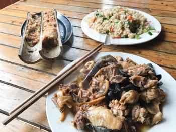 travel to China - asian dinner with chicken and mushrooms in rustic eatery in area Dazhai Longsheng Rice Terraces (Dragon's Backbone terrace, Longji Rice Terraces) country in spring