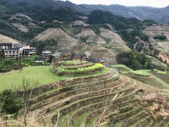 travel to China - view of Dazhai country with villages and terraced paddy fields from viewpoint Seven Stars Chase The Moon in area Longsheng Rice Terraces (Longji Rice Terraces) in spring
