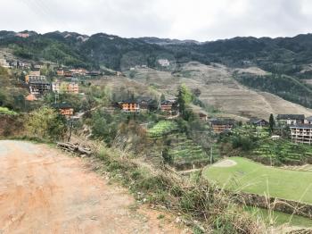 travel to China - country road on terraced hills in Dazhai village to viewpoint Seven Stars Chase The Moon in area Longsheng Rice Terraces (Longji Rice Terraces) in spring