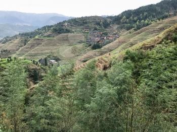 travel to China - view of overgrown mountains of Dazhai country in area Longsheng Rice Terraces (Longji Rice Terraces, Dragon's Backbone terrace) in spring