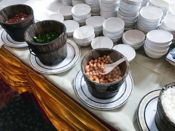 travel to China - empty bowls and foods and topping on table during breakfast in urban chinese restaurant in Longsheng city