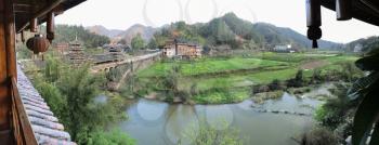 travel to China - panoramic view of Wind and Rain Bridge and gardens near river in Chengyang village of Sanjiang Dong Autonomous County in spring season