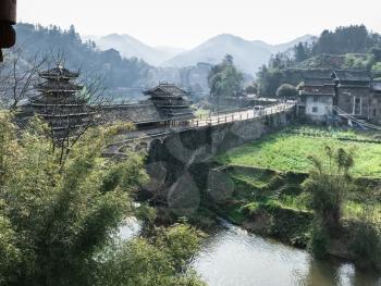 travel to China - covered Chengyang Wind and Rain Bridge over river (Fengyu Bridges of the Dong people) in Sanjiang Dong Autonomous County in spring evening