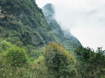 travel to China - clouds over green karst peaks in Yangshuo County in spring season