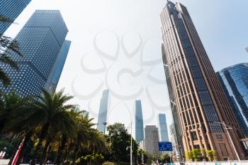 GUANGZHOU, CHINA - APRIL 1, 2017: skyscrapers along street in Guangzhou city in spring. Guangzhou is the third most-populous city in China with population about 13,5 mln