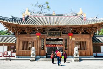 GUANGZHOU, CHINA - APRIL 1, 2017: people near doors to Guangxiao Temple (Bright Obedience, Bright Filial Piety Temple). This is is one of the oldest Buddhist temples in Guangzhou city