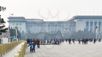 BEIJING, CHINA - MARCH 19, 2017: tourists and view of Great hall of The people on Tiananmen Square in spring. Tiananmen Square is central city square in Beijing