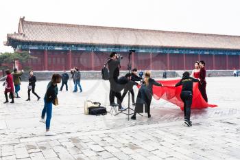 BEIJING, CHINA - MARCH 19, 2017: people in photosession at court of Imperial Ancestral Temple (Taimiao, Working People's Cultural Palace) in Beijing Imperial city in spring