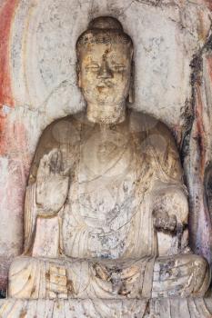 LUOYANG, CHINA - MARCH 20, 2017: statue in Middle Binyang Cave in Longmen Grottoes (Longmen Caves). The complex was inscribed upon the UNESCO World Heritage List in 2000