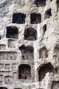 LUOYANG, CHINA - MARCH 20, 2017: caves in rocks of Chinese Buddhist monument Longmen Grottoes (Longmen Caves). The complex was inscribed upon the UNESCO World Heritage List in 2000