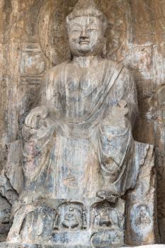 LUOYANG, CHINA - MARCH 20, 2017: carved figure in Longmen Grottoes (Longmen Caves). The complex was inscribed upon the UNESCO World Heritage List in 2000