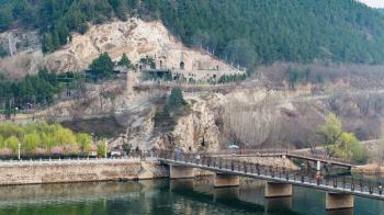 LUOYANG, CHINA - MARCH 20, 2017: above view of Manshui Bridge on Yi river between West and East Hills of Chinese Buddhist monument Longmen Grottoes ( Longmen Caves) in spring season