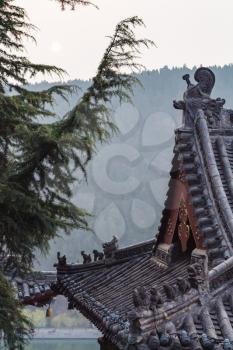 LUOYANG, CHINA - MARCH 20, 2017: roof of temple on East Hill of Chinese Buddhist monument Longmen Grottoes in spring. The complex was inscribed upon the UNESCO World Heritage List in 2000