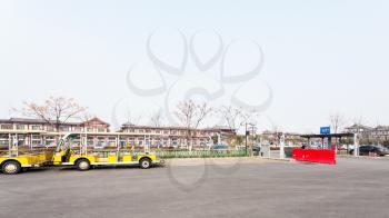 LUOYANG, CHINA - MARCH 20, 2017: parking place and hotel in area of Chinese Buddhist monument Longmen Grottoes (Dragon's Gate Grottoes, Longmen Caves) in valley Yi river in spring