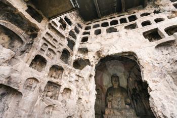 LUOYANG, CHINA - MARCH 20, 2017: Middle Binyang Cave with sculptures in Longmen Grottoes (Longmen Caves). The complex was inscribed upon the UNESCO World Heritage List in 2000