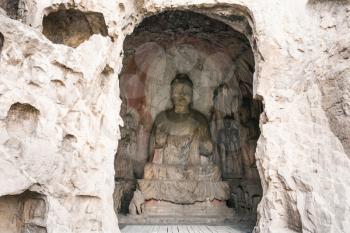 LUOYANG, CHINA - MARCH 20, 2017: Middle Binyang Cave with carved figures in Longmen Grottoes (Longmen Caves). The complex was inscribed upon the UNESCO World Heritage List in 2000