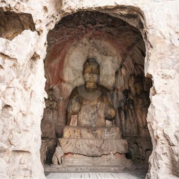 LUOYANG, CHINA - MARCH 20, 2017: Middle Binyang Cave with carved statues in Longmen Grottoes (Longmen Caves). The complex was inscribed upon the UNESCO World Heritage List in 2000