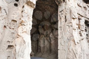 LUOYANG, CHINA - MARCH 20, 2017: carved statues in Middle Binyang Cave in Longmen Grottoes (Longmen Caves). The complex was inscribed upon the UNESCO World Heritage List in 2000