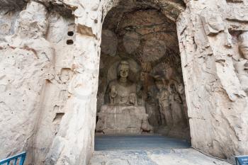LUOYANG, CHINA - MARCH 20, 2017: Middle Binyang Cave with Sakyamuni statue in Longmen Grottoes (Longmen Caves). The complex was inscribed upon the UNESCO World Heritage List in 2000