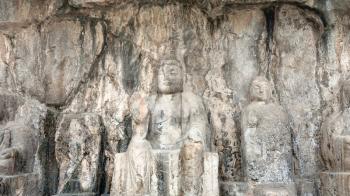 LUOYANG, CHINA - MARCH 20, 2017: carved Buddha figure in Longmen Grottoes (Longmen Caves). The complex was inscribed upon the UNESCO World Heritage List in 2000