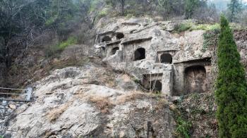 LUOYANG, CHINA - MARCH 20, 2017: caves in slope of West Hill of Chinese Buddhist monument Longmen Grottoes. The complex was inscribed upon the UNESCO World Heritage List in 2000
