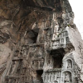 LUOYANG, CHINA - MARCH 20, 2017: carved figures and rooms in West Hill of Chinese Buddhist monument Longmen Grottoes. The complex was inscribed upon the UNESCO World Heritage List in 2000
